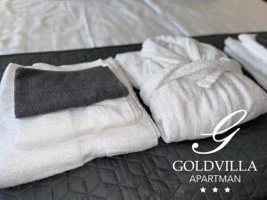 a couple of towels sitting on top of a bed at Goldvilla Apartman in Zalakaros