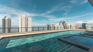 a swimming pool on the roof of a building at Elegant Studio Overlooking Costa del Este Park in Panama City