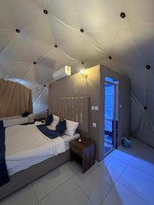 a bedroom with two beds in a tent at Bubbles Desert Camp Jeep Tours in Wadi Rum
