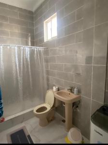 a bathroom with a toilet and a sink at Apartamento de recreación vista al mar in Boca Chica