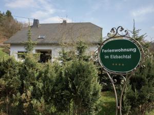 a sign in front of a house with a house at Tranquil Eifel Hideaway in Lirstal