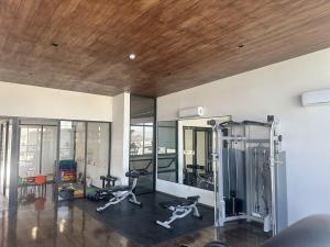 a gym with two treadmills and two exercise bikes at Amar Apartment - 24 hour security, Comfort in Tijuana