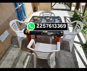 a table and chairs sitting on a patio with a table and a plate at Es Lo Que Hay in Nueva Atlantis