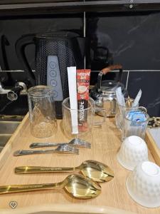 a table with spoons and a toaster on a counter at مسكن راحتك للشقق المخدومه in Tabuk
