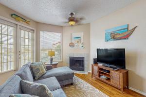 a living room with a couch and a television at Beach Club 280 in Padre Island
