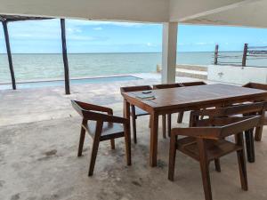 ChuburnáOn Beach Seaside Sunset Haven 1 Nature & Chill的一张木桌和椅子,享有海景