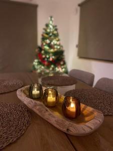 弗朗科尔尚La Roanneuse - Cosy Chalet的桌子上放着一个托盘，托盘上放着三根蜡烛和一棵圣诞树。