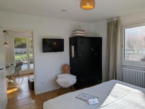 a bedroom with a bed and a black cabinet at die Übernachterei in Hüfingen
