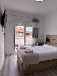 a bedroom with a bed and a large window at Dos Mundos in Motril +45 photos