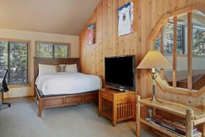 a bedroom with a bed and a flat screen tv at 14 Mt Hood in Sunriver