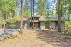 a house in the woods with a lot of trees at 14 Mt Hood in Sunriver