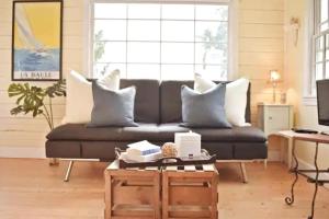 a living room with a couch and a coffee table at Charming Beach Cottage with Ocean Views & Sauna in Shoreline