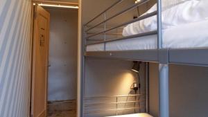 a bunk bed in a room with a mirror at Little Birds Hostel in Omihachiman