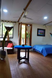 a room with a bed and a blue table in it at Shark House in Bellavista