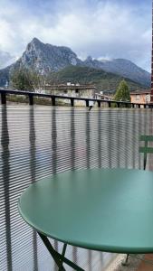 a table on a balcony with a view of the water at Pura Vida Apartmento in Ramales de la Victoria