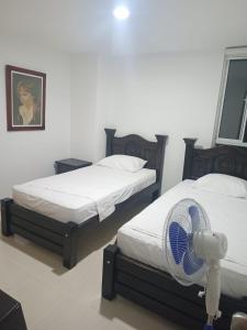 Ένα ή περισσότερα κρεβάτια σε δωμάτιο στο Apt san gil por dias amoblado