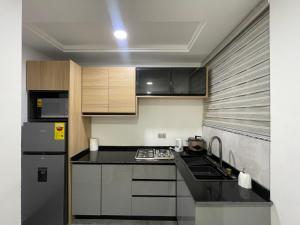 a kitchen with a black counter top and a refrigerator at Villa Fafa in Ho
