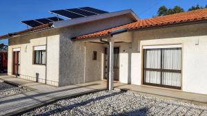 a house with solar panels on the roof at Casa dos Pomares in Figueira da Foz