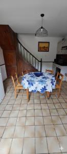 a table and chairs in a kitchen with a blue and white table at gîte 8 personnes Les Marqueries in La Flèche +6 photos