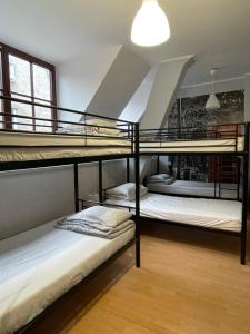 two bunk beds in a room with a staircase at Hostel Universus in Gdańsk