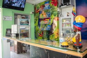 a restaurant with a counter with a counter top at Hostal Kumbaya in Santa Marta