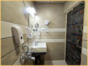 a bathroom with a sink and a mirror at Rooftop SEA VIEW - SWIMMING POOL - Hotel The LB Resort Sea View Hotel Near Jagannath Temple - Parking And Resturent - Breakfast Included - A Fully Air Conditioning Luxuary Rooms - Top service in Puri +10 photos