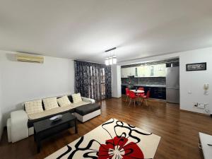 a living room with a couch and a table at Modern apartment in Ford-Ferval area, Craiova in Craiova