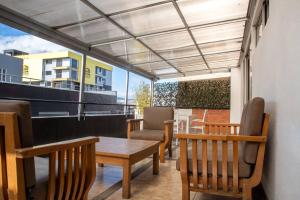 a balcony with a table and chairs on a building at Hotel Regency Suites La Feria in Bogotá +39 photos