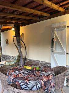 a table with a table cloth on top of it at Résidence Flores De Maria in Le Marin