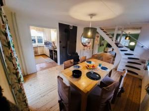 a living room with a table and a staircase at Villa Clara in Blankaholm
