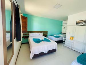 Postel nebo postele na pokoji v ubytování Ilha de Itacimirim Pousada