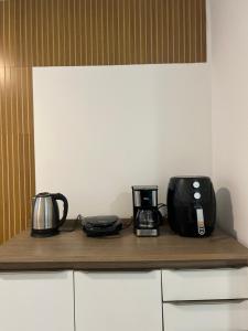 a counter with two coffees and a coffee maker on it at Apartamento vizinho ao Shopping Manaira próx à Praia in João Pessoa