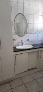 a bathroom with a sink and a mirror at 18 Laburnum Lodge in Durban +14 photos
