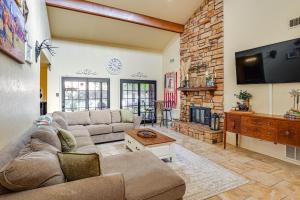 a living room with a couch and a fireplace at 4 Mi to Dtwn The Crash Site Roswell Home! in Roswell