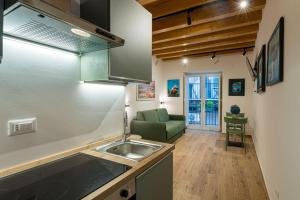 a kitchen with a sink and a couch in a room at Caminneci Palace Boutique in Palermo