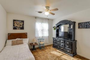 a bedroom with a bed and a dresser with a television at 4 Mi to Dtwn The Crash Site Roswell Home! in Roswell