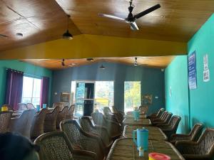 a room with chairs and wooden tables with drinks on them at Kaafirana Adventure Camps and Cottages in Shivpuri