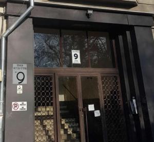 a front door of a building with signs on it at Cisimigu Garden Studio in Bucharest +2 photos