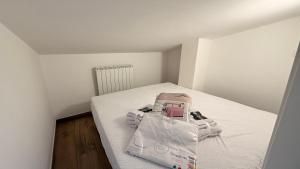 a small room with a bed with a bag on it at Nicos House in Campo di Giove