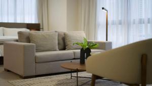 a living room with a couch and a table at Furnished Studio with partial Ocean & City View in Panama in Panama City