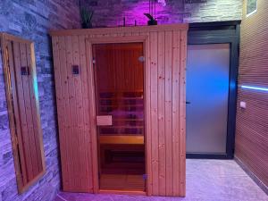 a wooden locker in a room with a door at Dubai Spa Apartments in Novi Sad +9 photos