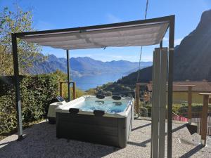 a hot tub under a canopy with a view at Eden Garden in Fonteno