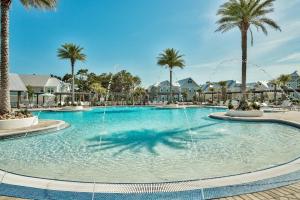a large pool with a fountain in a resort at Prominence Southside - Blue Skies in Watersound Beach +9 photos