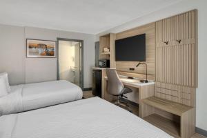 a hotel room with two beds and a desk at Best Western Of Walterboro in Walterboro +34 photos