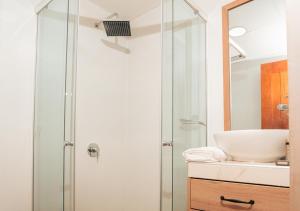 a bathroom with a glass shower and a sink at Aranwa Vichayito Beach Resort in Vichayito
