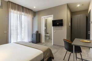 a bedroom with a bed and a desk and a television at Testani Guest House Special in Anagni