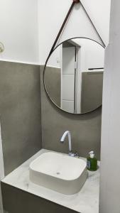 a bathroom with a sink and a mirror at Apartamento Bela Vista in Canoinhas +5 photos