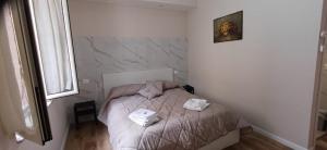 a small bedroom with a bed with towels on it at la primavera in Palmi