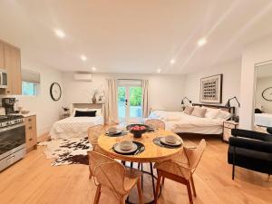 a kitchen and living room with a table and chairs at Hillside Haven | Boutique Spanish Escape in Ojai