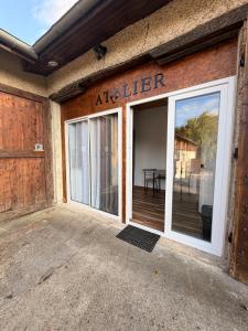 an entrance to an apartment building with a sliding glass door at L'atelier in Festigny +3 photos